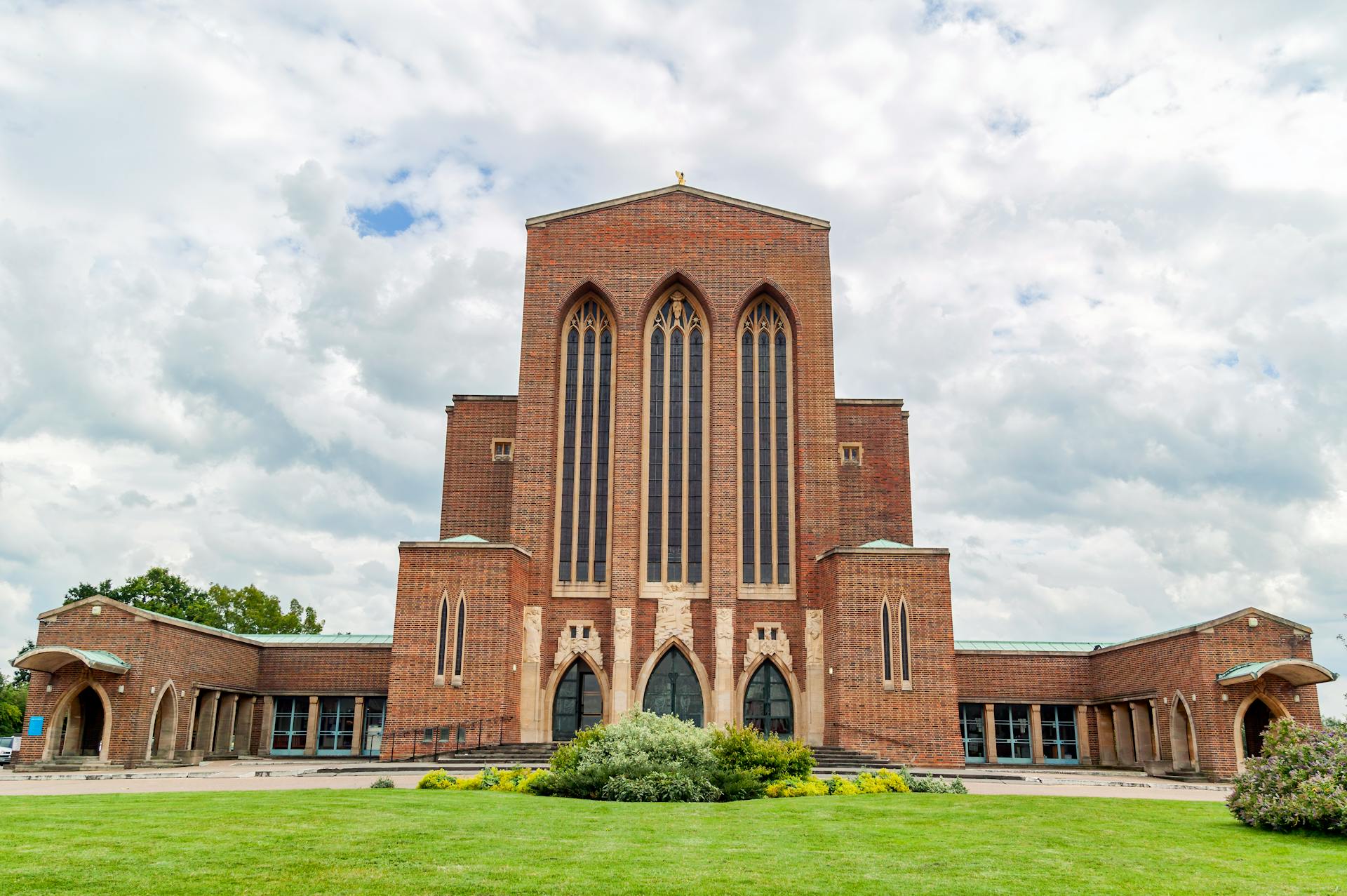 Impressive Guildford Cathedral with dramatic arches and cloudy sky in England.