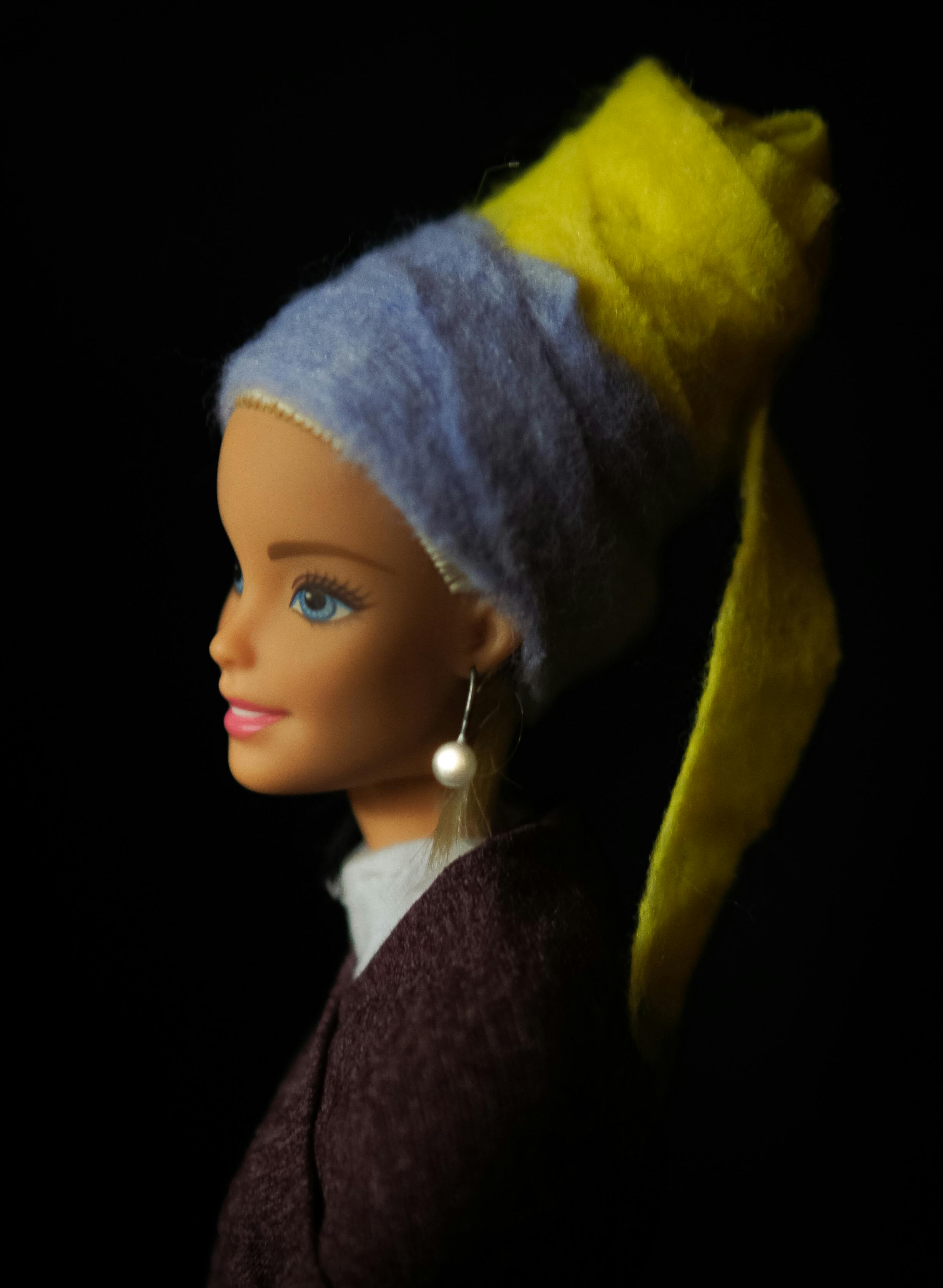 doll with blue and yellow head wear