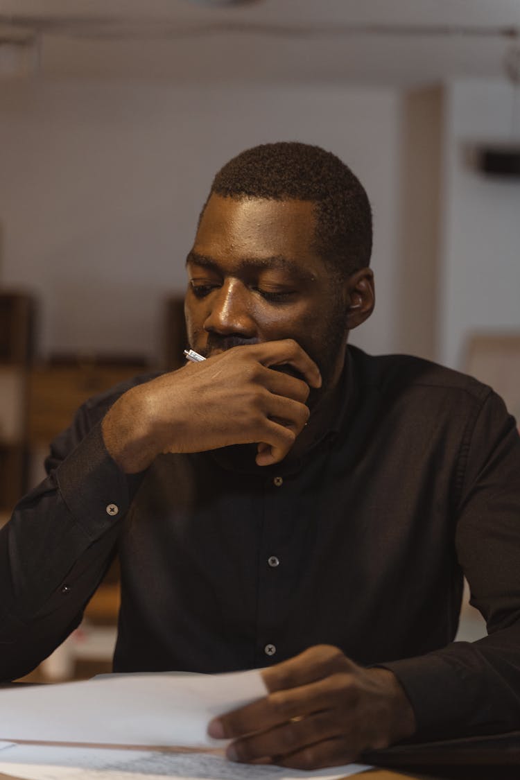 Man In Black Button Up Shirt In Deep Thoughts
