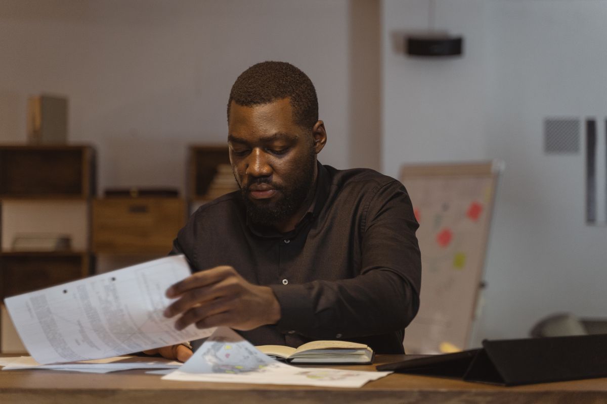 A serious businessman reviews important papers in a modern office setting