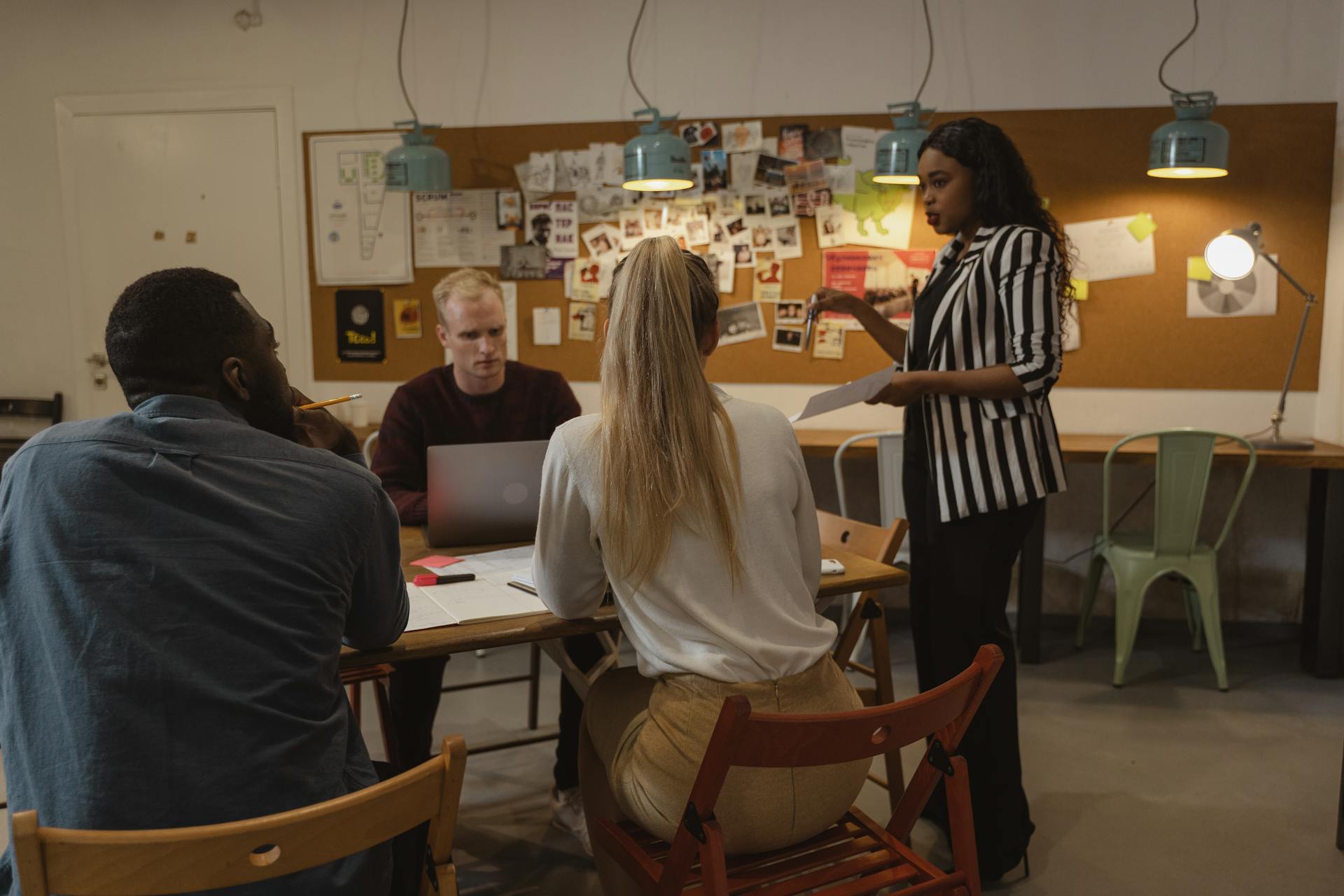 A diverse group of professionals collaborating in a modern office setting, fostering teamwork and communication.