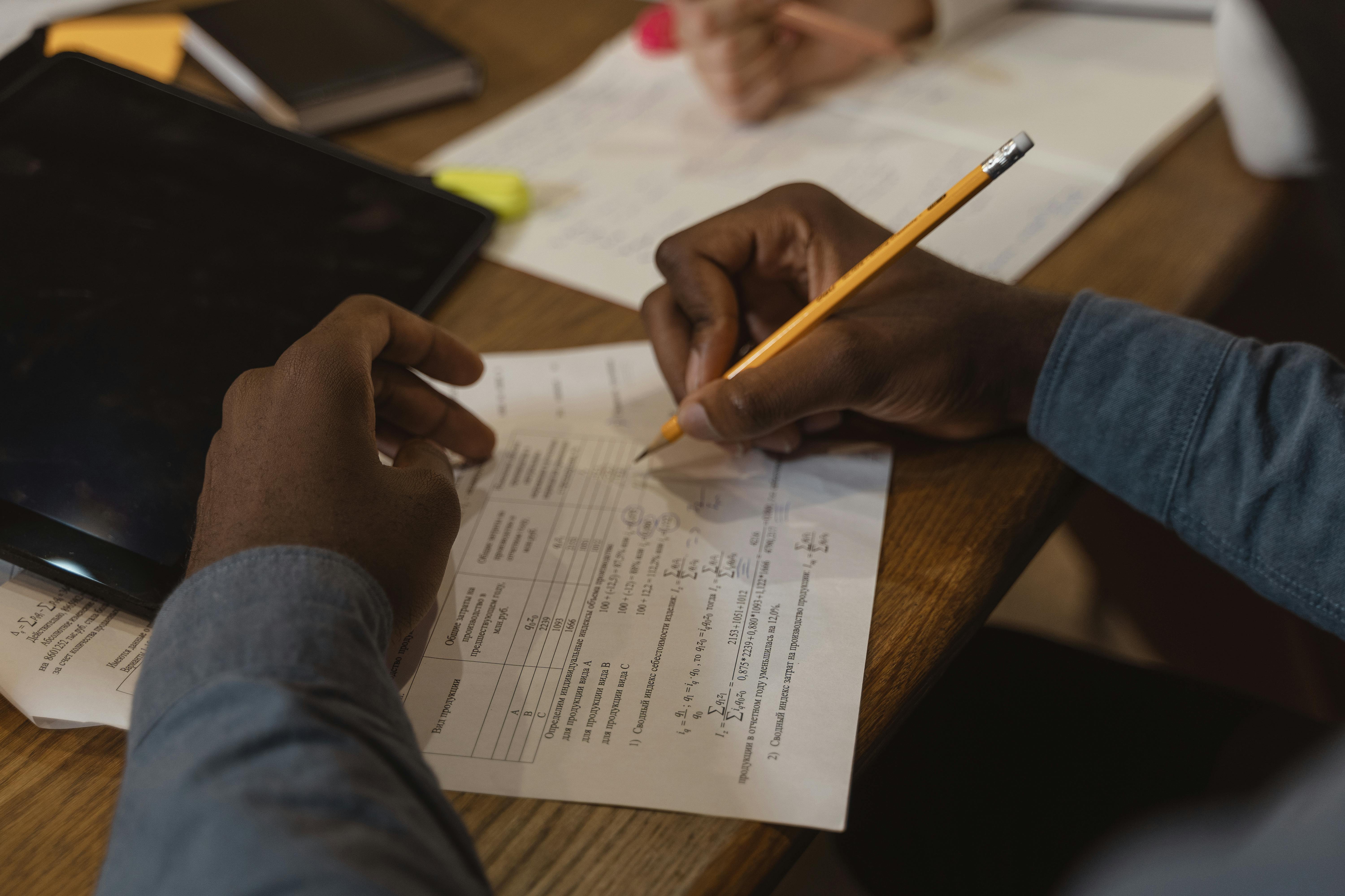 person writing on white paper