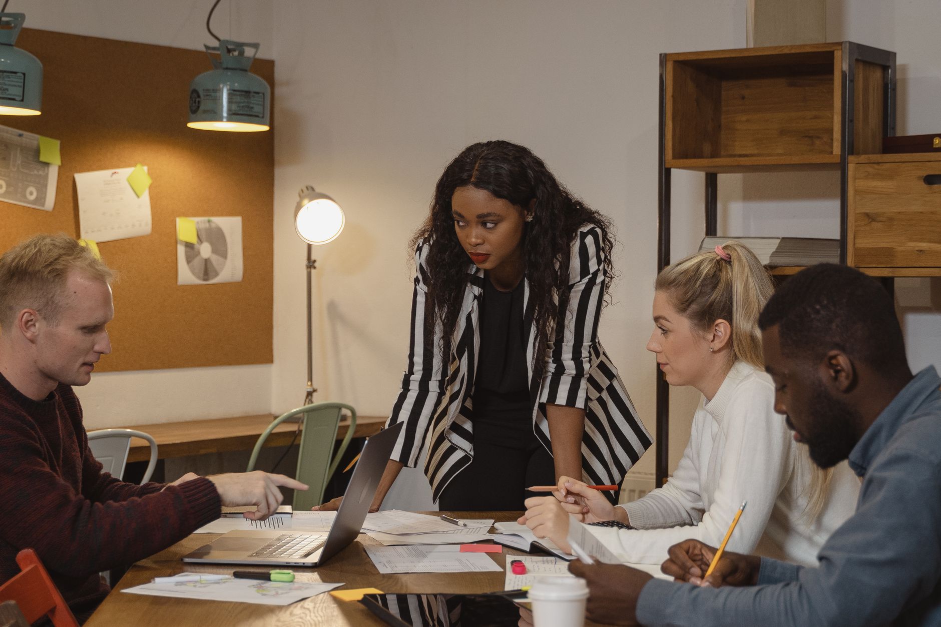 A multicultural team collaborating in a modern office environment, focused and engaged in a project discussion.