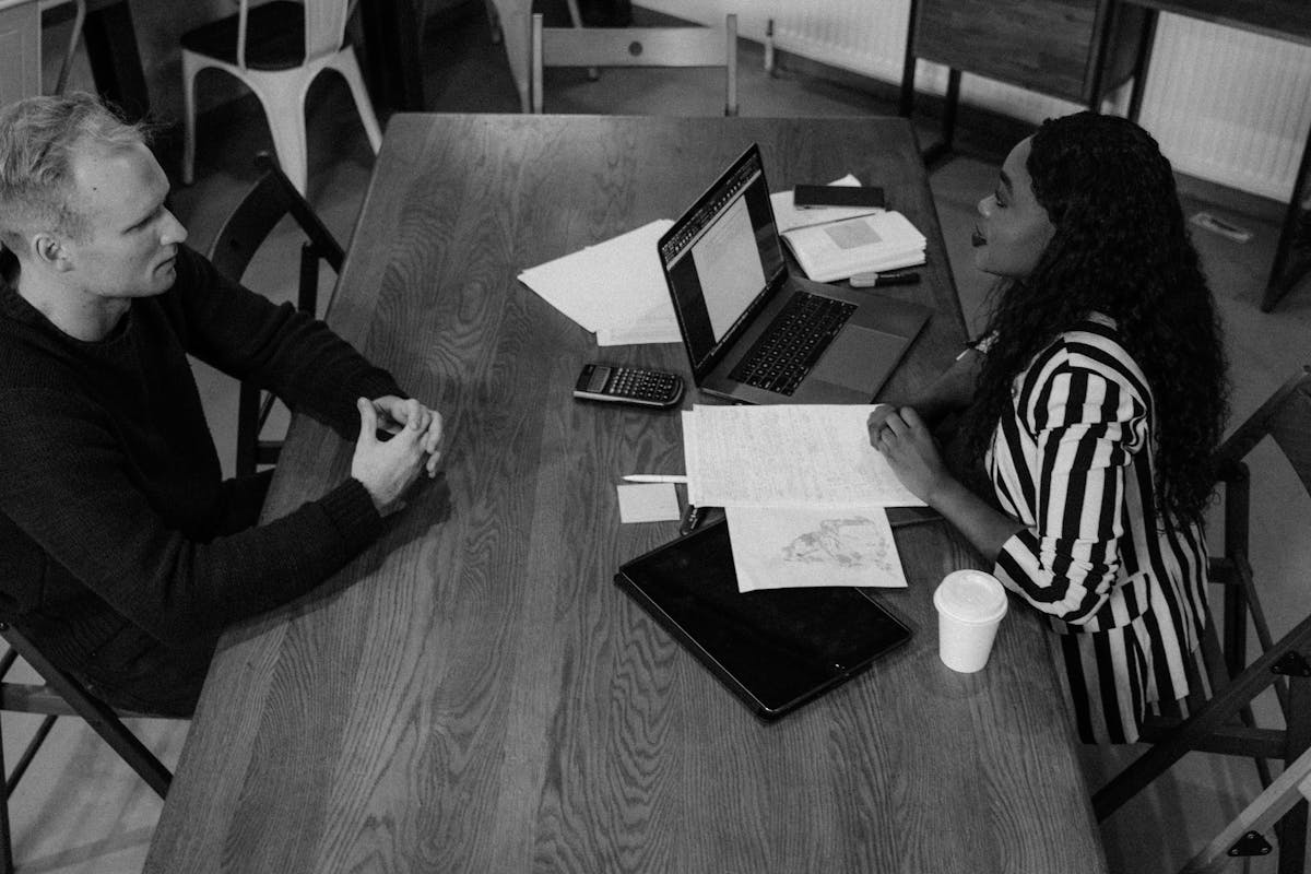 Two professionals having a supportive conversation in a private office setting