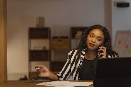 A Woman Talking on a Phone in the office