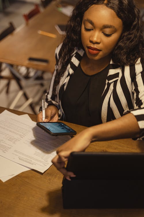 Woman in Black and White Adidas Shirt Sitting at Table