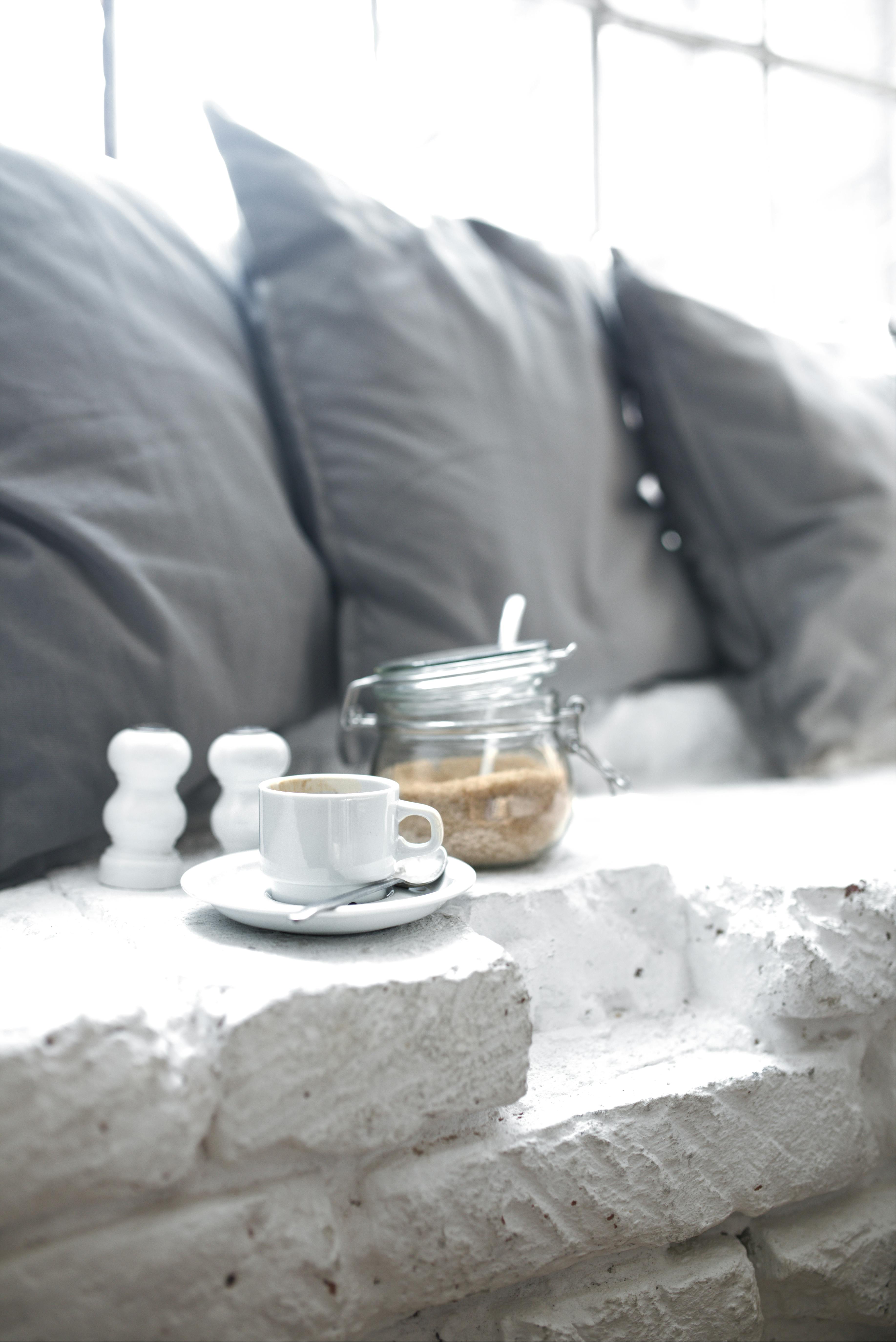 Free Warm and inviting living room setup featuring a cup of coffee and sugar jar. Stock Photo