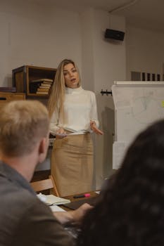 Businesswoman presenting data in a professional office setting with colleagues.