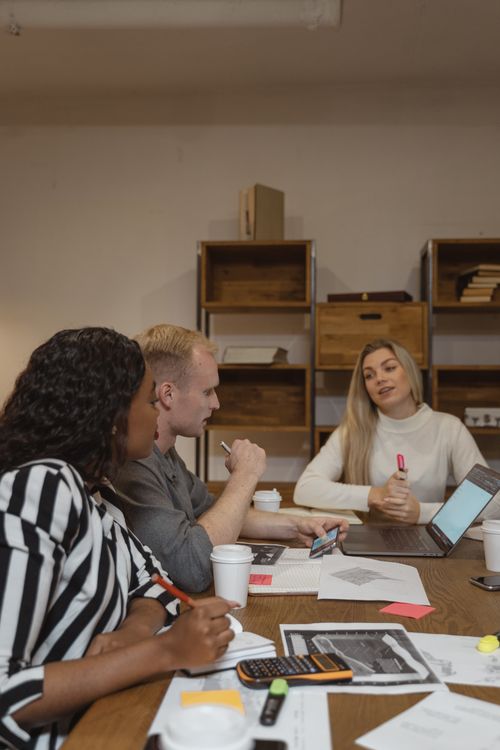 Free A diverse group of professionals collaborating on business strategies during an office meeting. Stock Photo