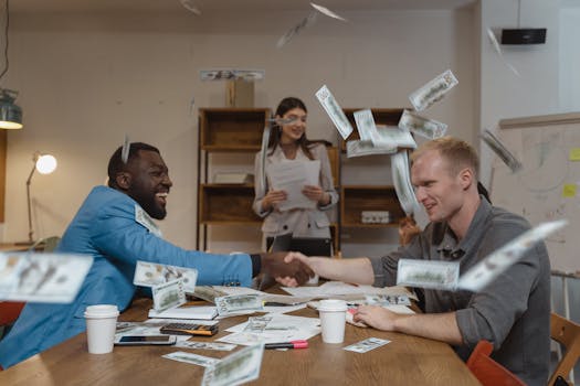A lively office meeting with colleagues and money flying around, depicting success and finance.