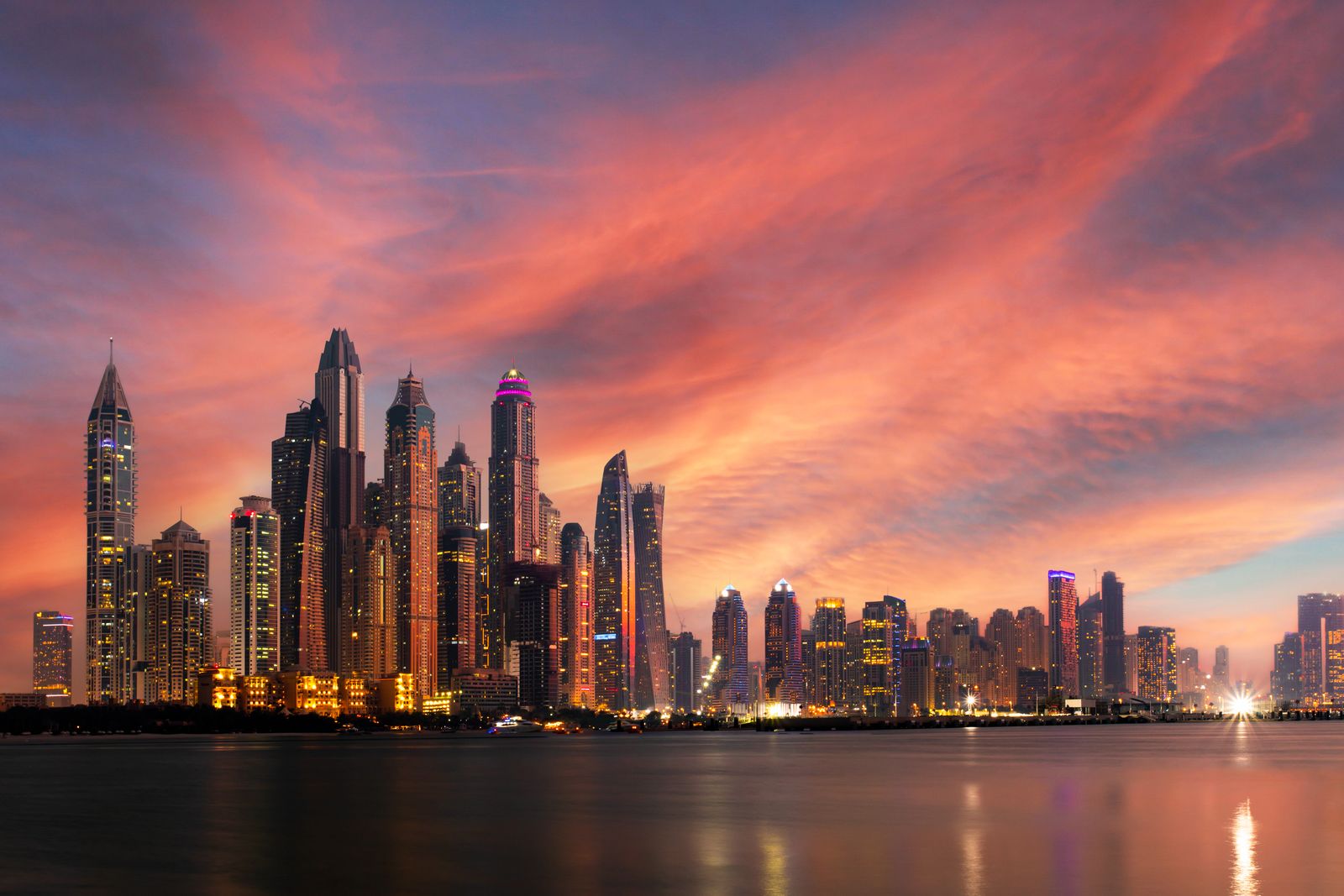 Dubai skyline at dusk behind a closing call to action