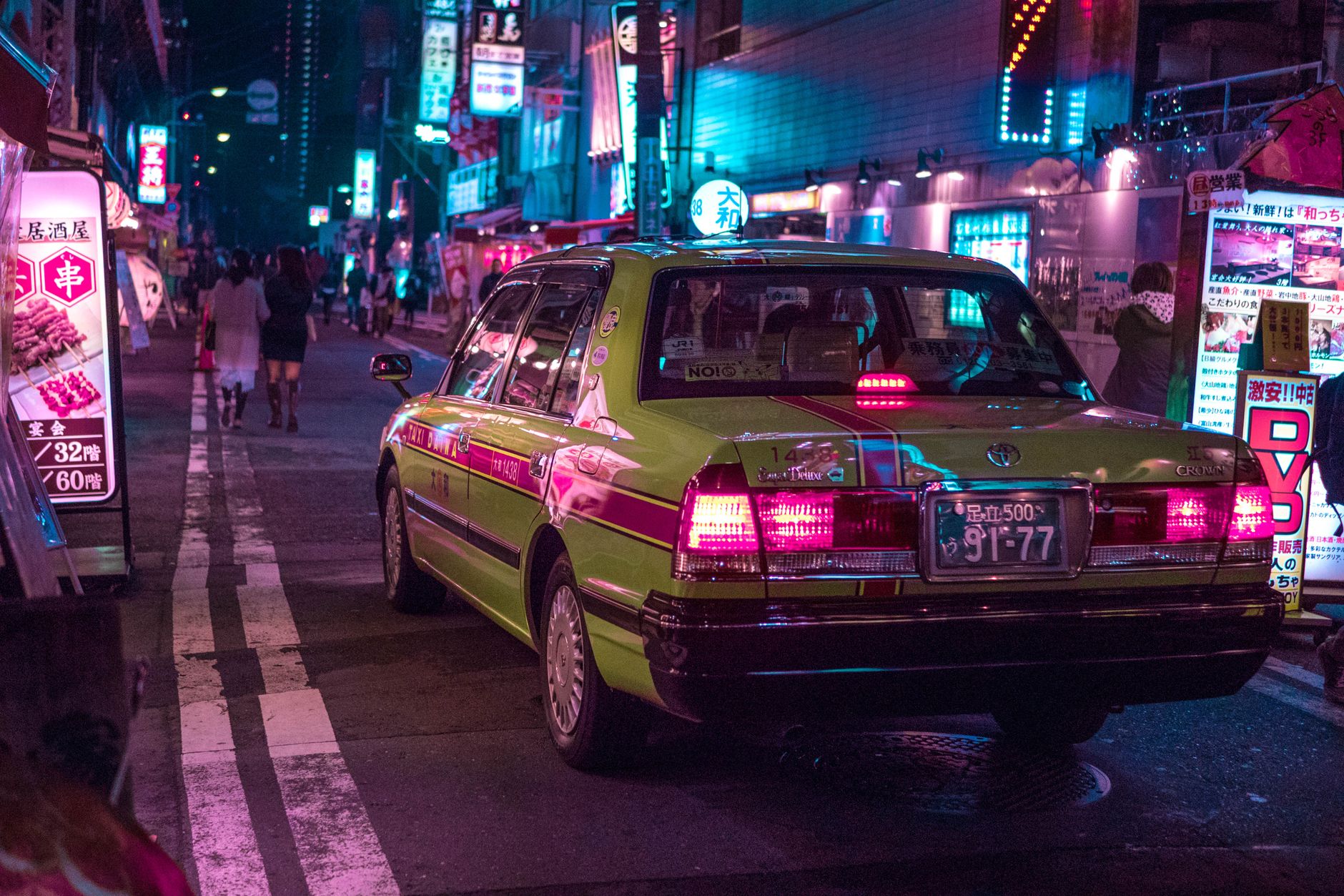 Tokyo Private Car Tours: Costs, Routes and Booking Tips Vibrant Tokyo street at night featuring a taxi under neon lights