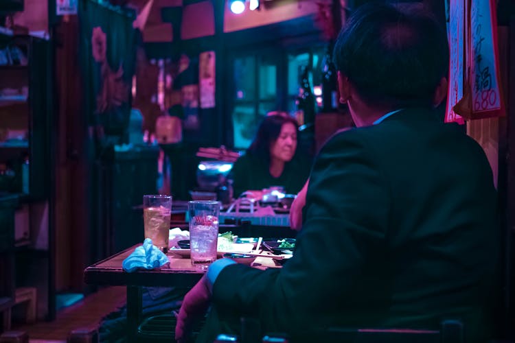 Man In Black Suit Having Dinner In A Restaurant