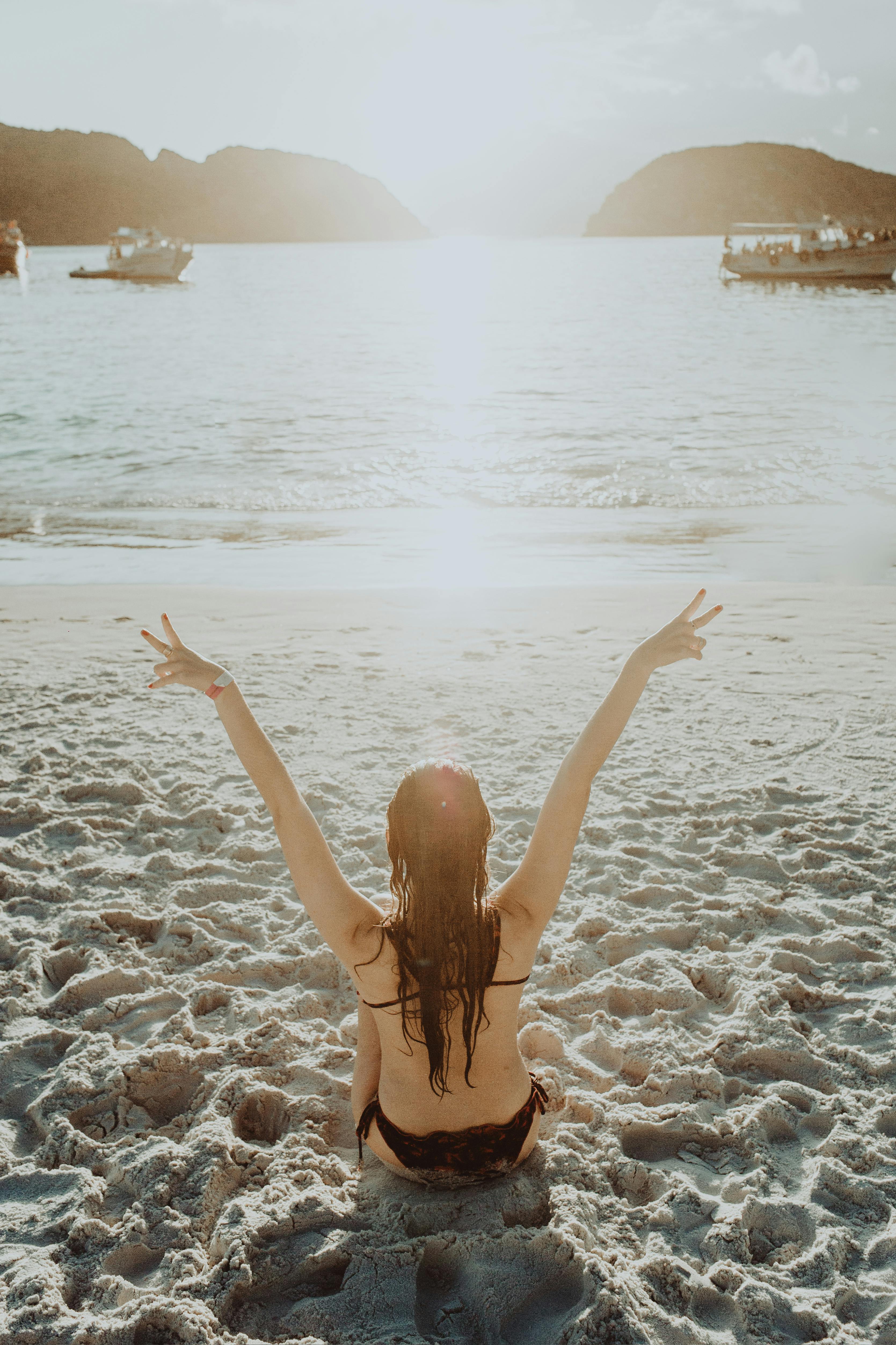 young woman enjoying sea on sandy shore