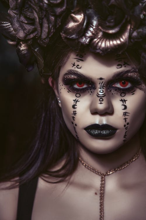 Spooky woman with makeup of spells