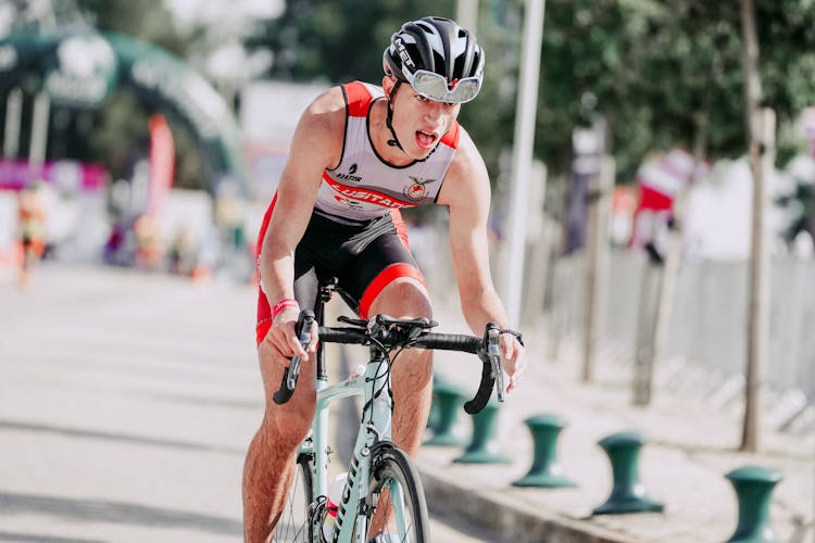 Focused Cyclist Riding Bike During Competition In Town