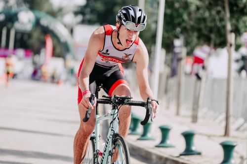 Free Young fit male bicyclist with open mouth riding bicycle on asphalt road during race in city Stock Photo
