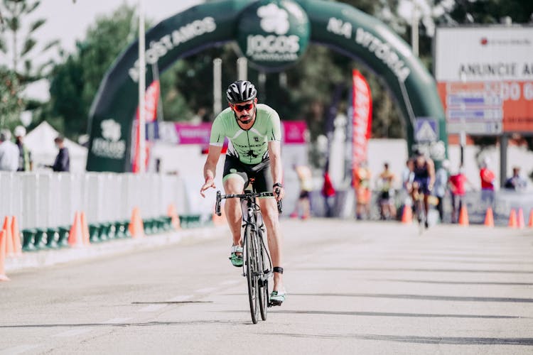 Sportsman Riding Bicycle On Road During Race In Town