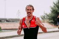 Strong sportsman running on asphalt road