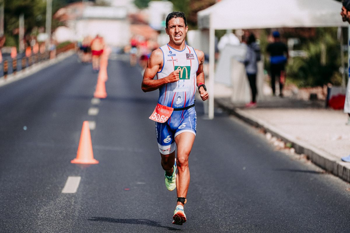 Focused athlete running outdoors in performance apparel