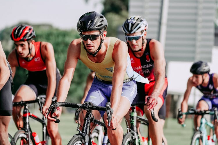 Group Of Cyclists Riding Bikes During Race