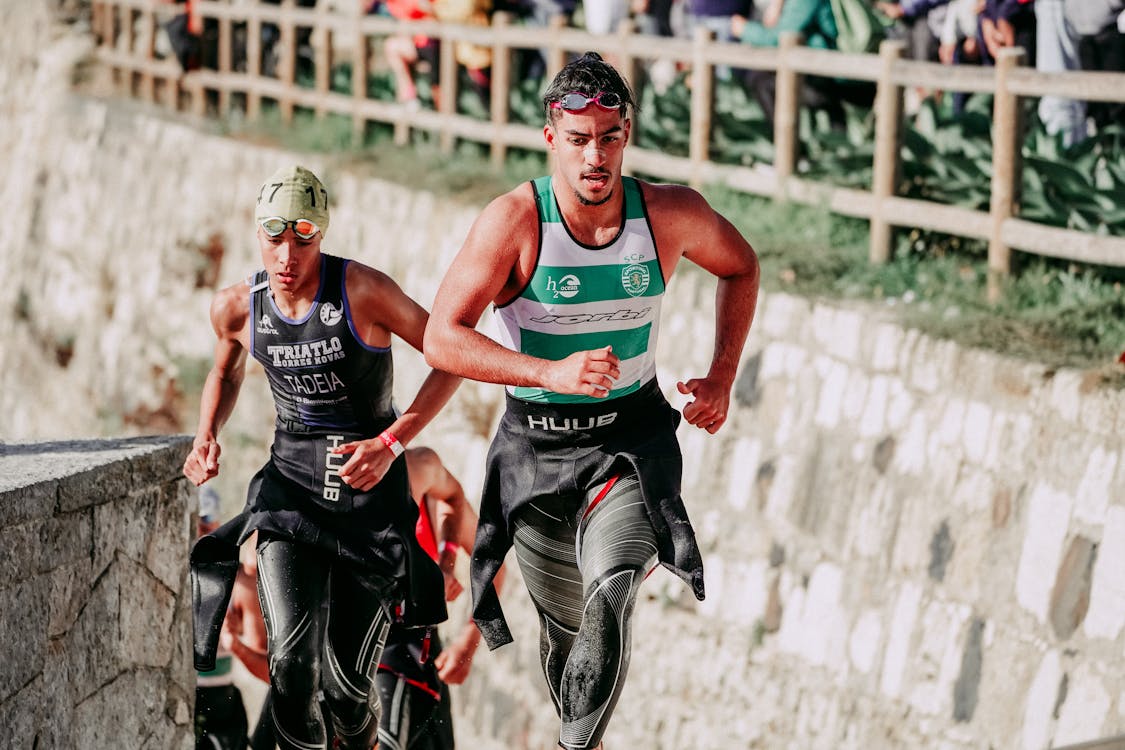 Strong athletes sprinting during triathlon race