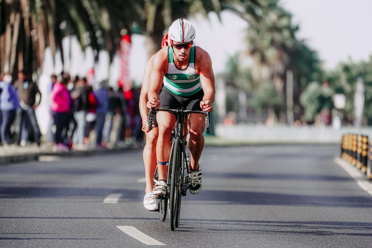 Cyclist wearing helmet and protective cycling equipment