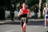 Muscular runner on paved road in daytime