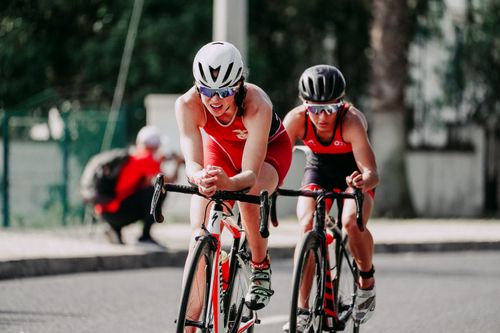 Free Unrecognizable cyclists riding bikes with hands on handlebars while taking part in bicycle race in daytime on blurred background Stock Photo