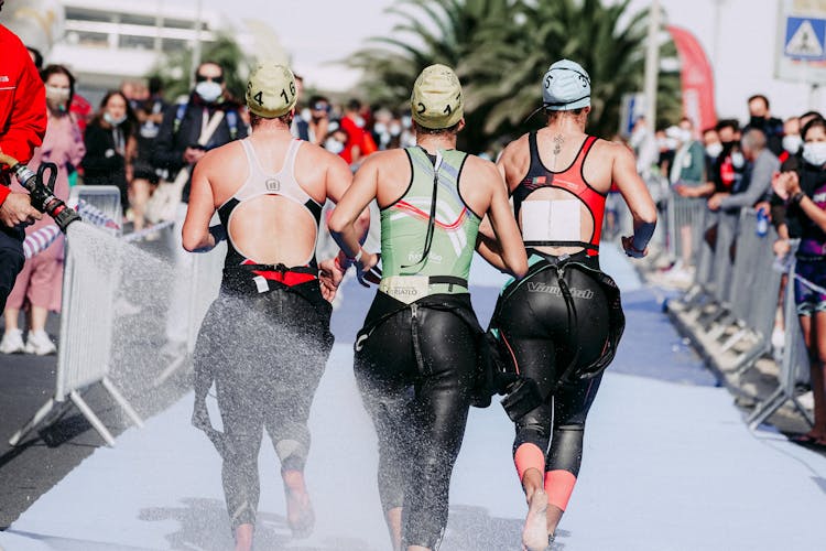 Group Of Women Running On Wet Track