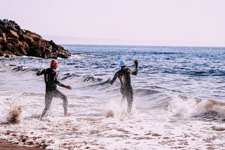 Anonymous Sportspeople Running Into Sea