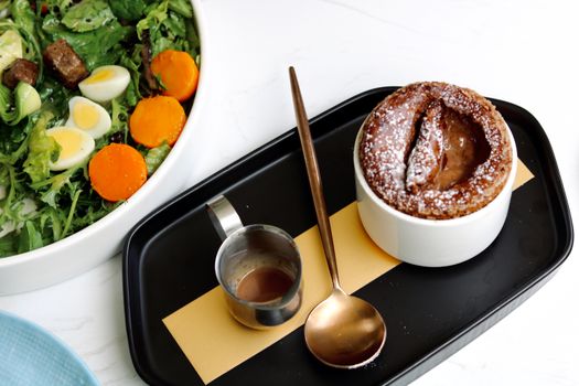 Delicious fresh salad paired with a warm, rich dessert for a perfect meal combination.