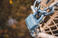 Chain link fence closed with lock in countryside