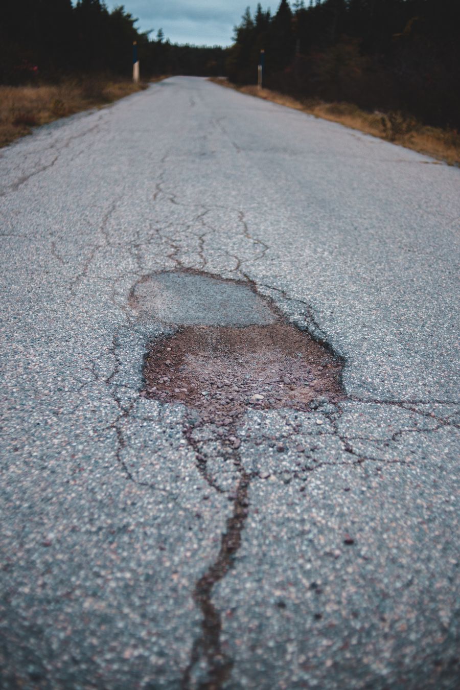 Deteriorated asphalt showing cracking and surface wear typical of Columbus-area driveways