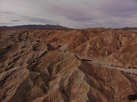 Aerial view of rugged desert terrain in San Diego County, showcasing geological formations and barren wasteland.