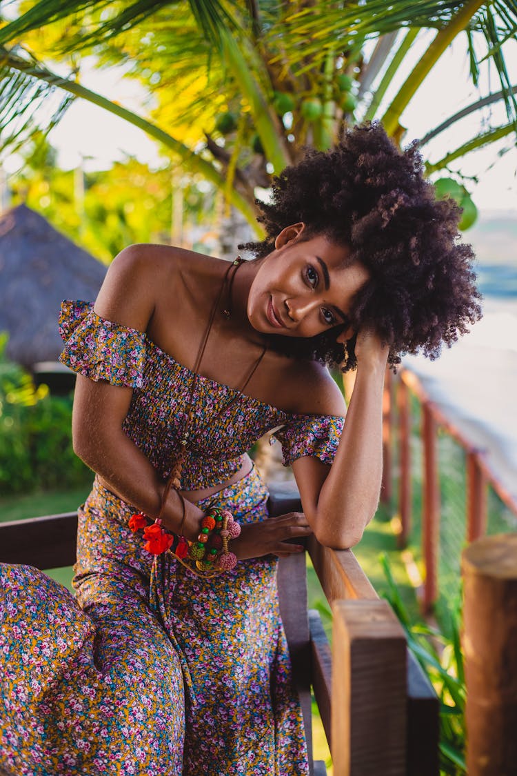 Trendy Black Woman Near Fence And Palm Tree