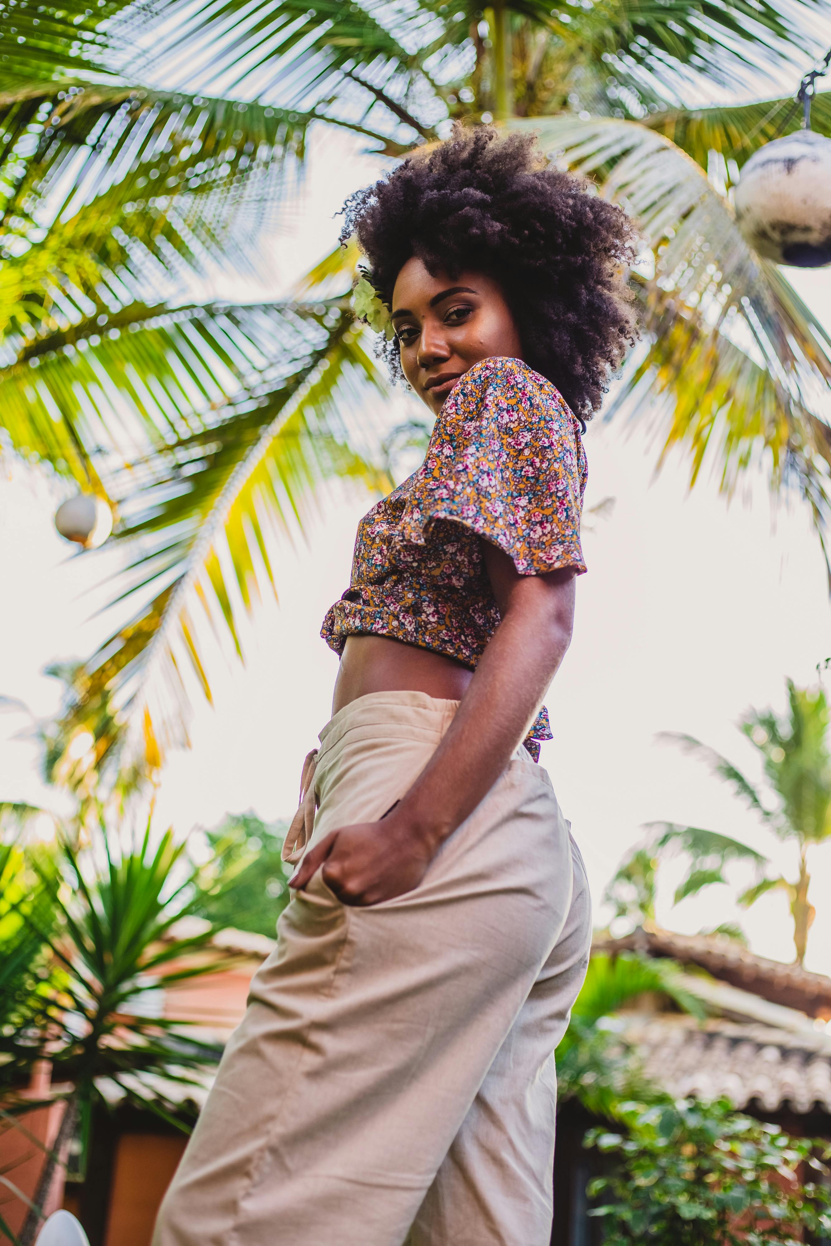 Trendy black woman under palm trees in summer · Free Stock Photo