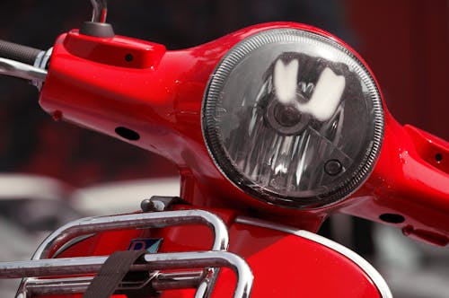 Silver Headlight on Red Motorcycle