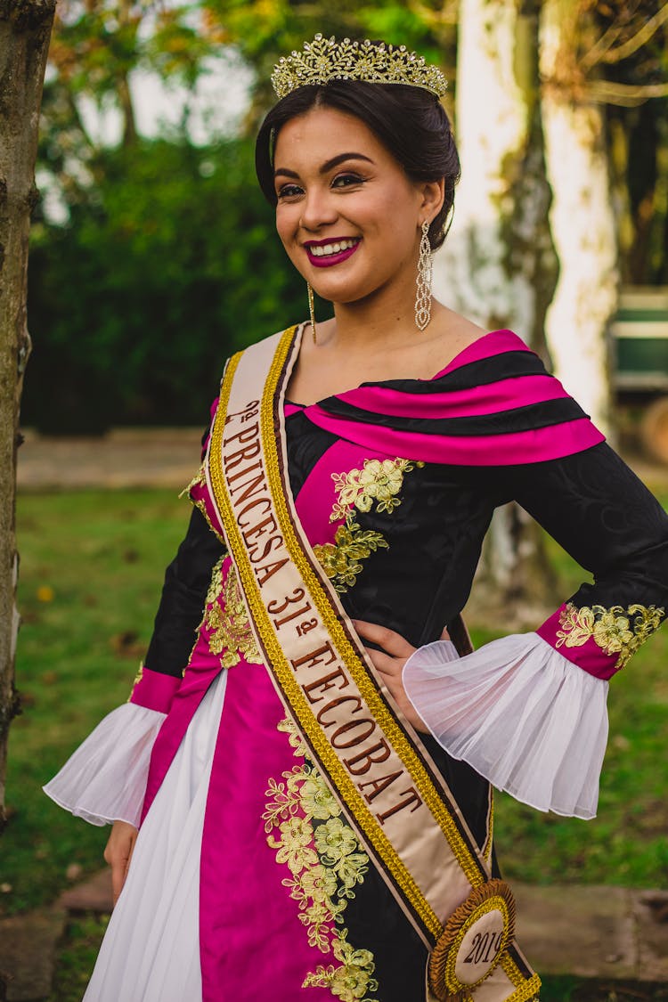 Cheerful Ethnic Beauty Contest Winner In Elegant Wear In Park