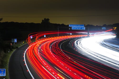 Time Lapse Photography of Car Passing by the Winding Road during Nighttime