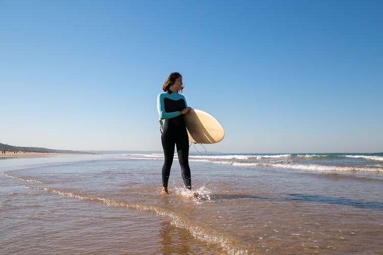 Woman In Full Body Swimwear Walking On Water