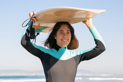 A Surfer Carrying a Surfboard