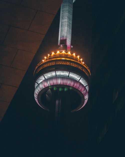 Free A night view of the illuminated Buckham Tower in London, Ontario, showcasing vibrant colors and architectural design. Stock Photo