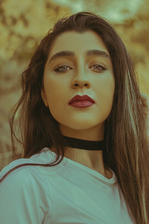 Woman in White Crew Neck Tshirt with Black Choker
