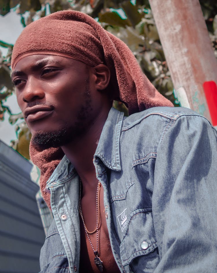 Man In Blue Denim Jacket With Red Headwear