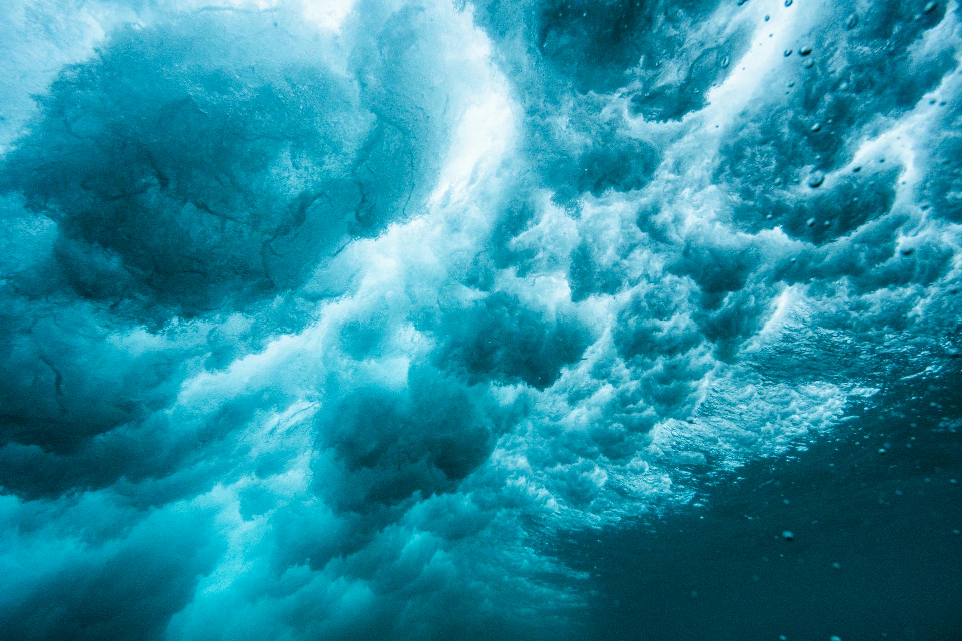 Captivating underwater scene showcasing turbulent ocean currents with vibrant blue hues.