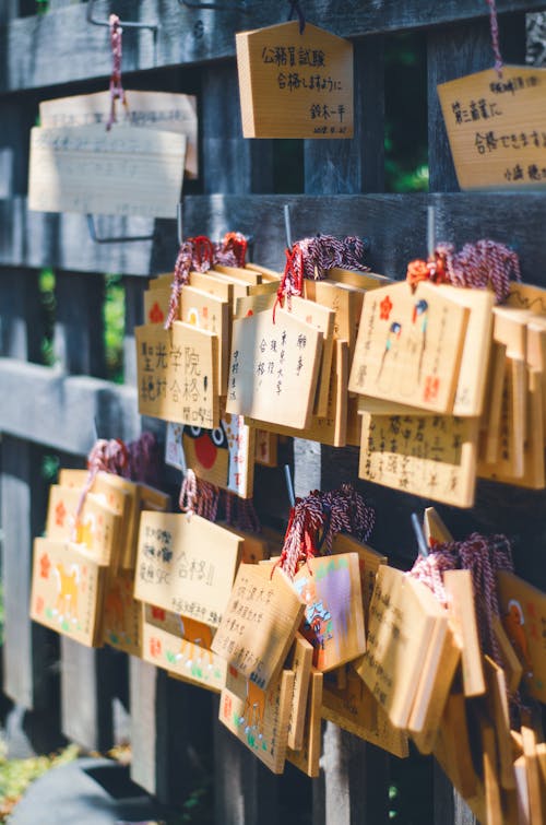 Ema Votive Plaques Hanging on a Wooden Fence