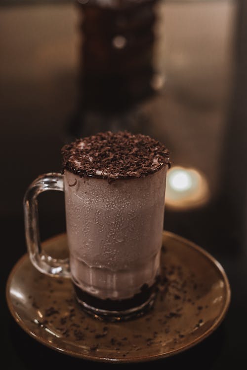 A Clear Glass Mug With Chocolate Drink and Toppings