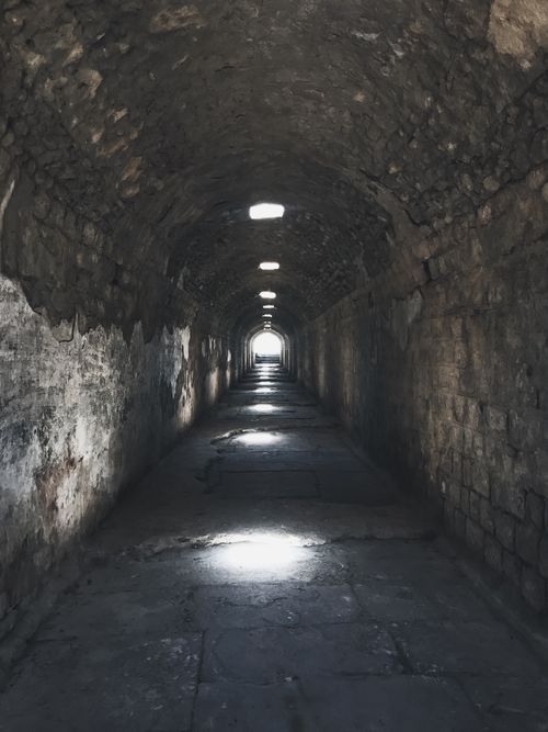 Free Explore the atmospheric stone tunnel with light filtering through vents, a perfect setting for adventure or mystery themes. Stock Photo