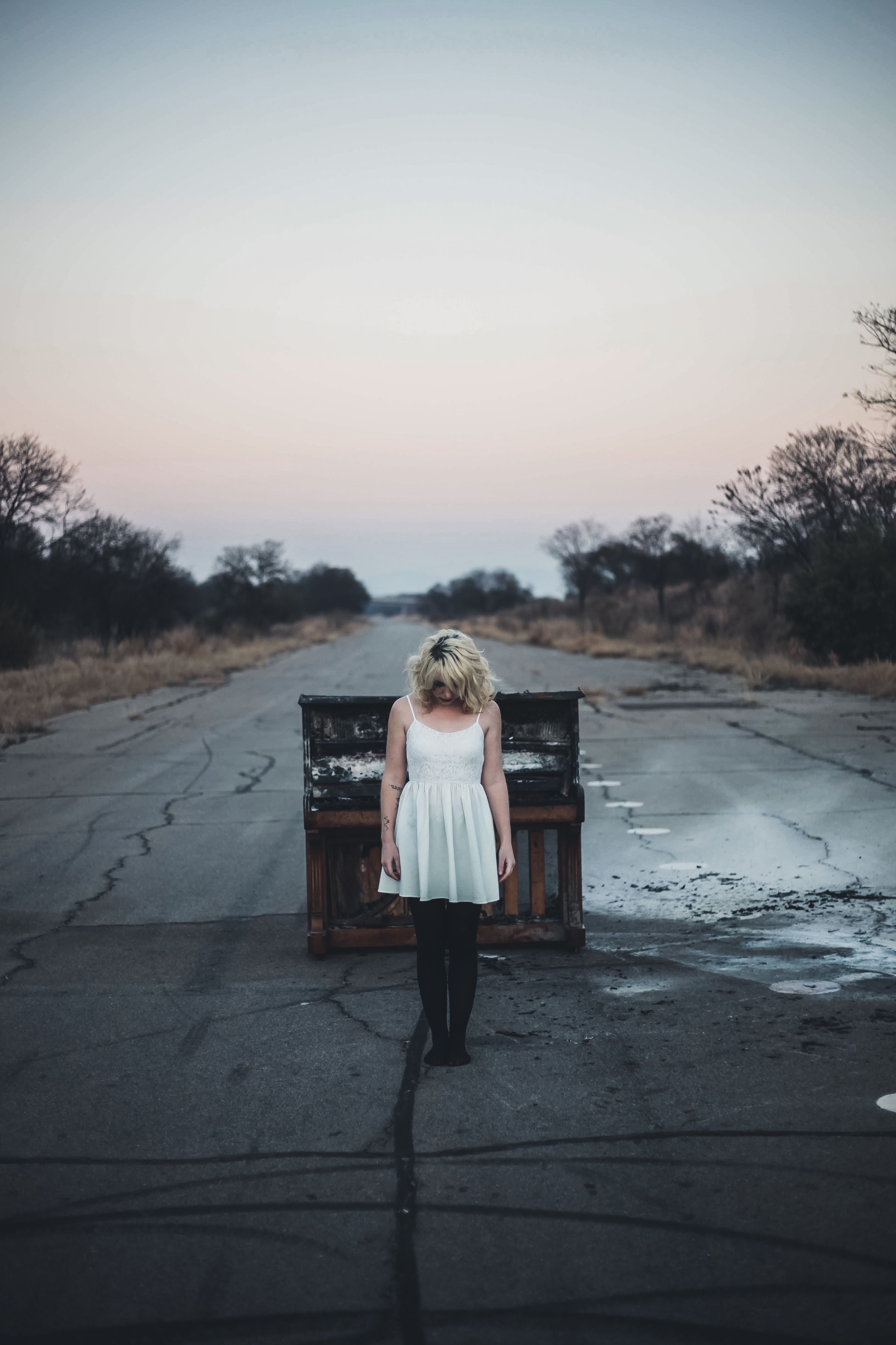A Woman in White Dress Standing on a Concrete Road · Free Stock Photo